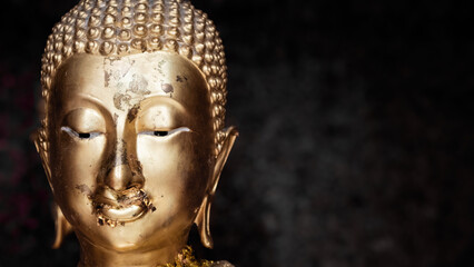 Fototapeta na wymiar Buddha's face on blur background, Believe in Buddhism, Buddha statue used as amulets of Buddhism religion