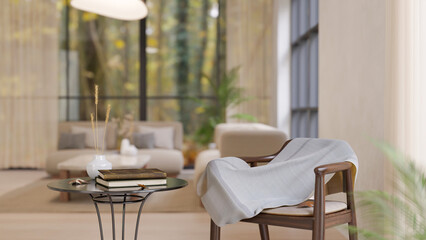 A modern Scandinavian living room with books on a side table and a cosy blanket on a wooden chair.