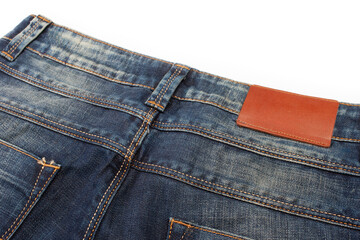 Closeup of Back Side of Pair of Dark Blue Washed Mens Jeans On Pure White Background.