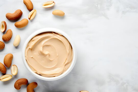 A Jar Of Peanut Butter On A Marble Surface  With Nuts. View From Above. Promotional Photo. Top View