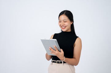 A positive Asian businesswoman with a digital tablet is standing against isolated white background.