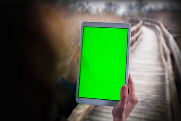 Adult Woman Hand Using A Tablet With Green Screen Hiking in a Remote Location