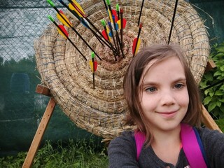 Archery for child. Little girl with bow and arrow