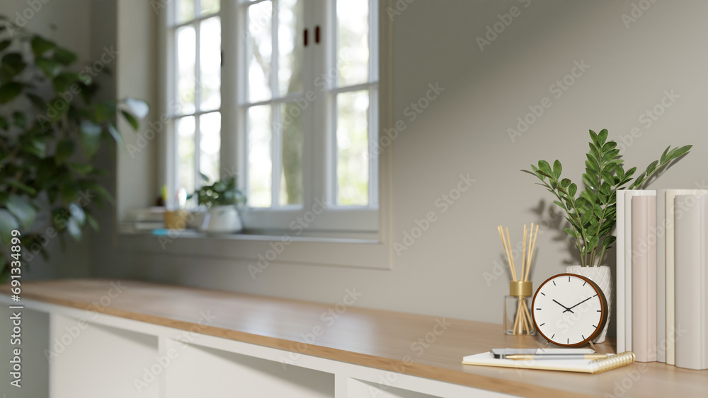 Poster a copy space on a minimal wooden shelf against the window and white wall in a scandinavian room.