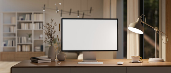A computer mockup, a table lamp, and accessories on a desk in a modern spacious home office room.