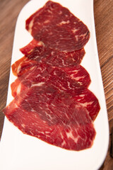 Dry-cured Spanish ham, Serrano ham, Bellota ham, Italian prosciutto crudo or Parma ham, wagyu slice. High quality photo