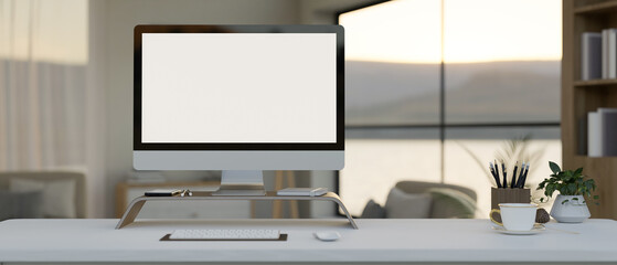 A modern office desk workspace, A computer blank monitor mockup on a computer stand on a white desk.