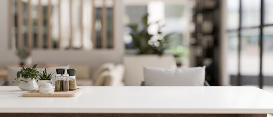 Mockup space for displaying your product on a white dining table in a modern, spacious white lounge.