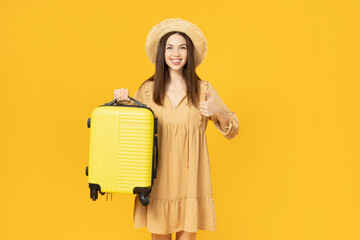 Young girl with a suitcase on a yellow background.