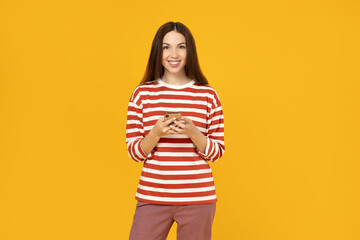 Obraz premium A girl with a phone on a yellow background.