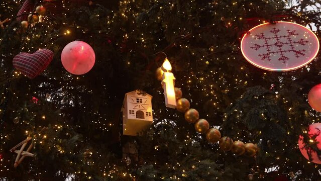 giant hand made ornaments and candles in town square christmas tree at Festive Christmas market in Strasbourg, France Europe