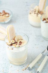 Milk mousse dessert with nuts in glasses	