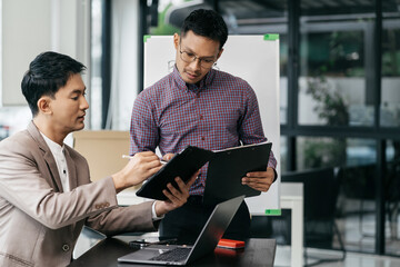 Business corporate team brainstorming, planning strategy having a discussion Analysis investment researching with chart at office desk documents in office.