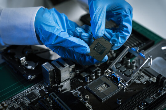 Macro photo of a finger touching a laptop chip close up, computer hardware and technology concept.