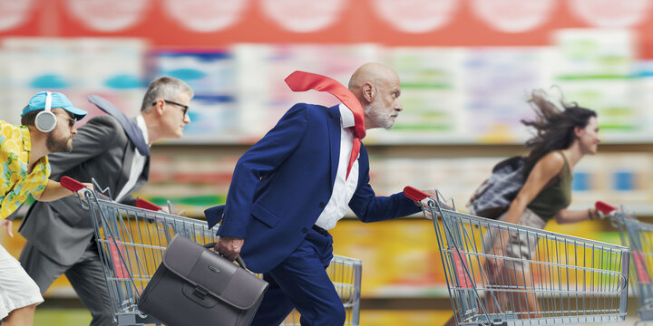 Fast people pushing shopping carts at the supermarket