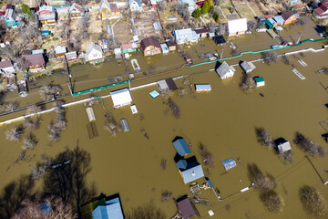 Heavy spring flood of the river with water reaching dacha plots located in the lowlands