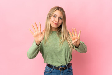 Young blonde woman isolated on pink background counting nine with fingers