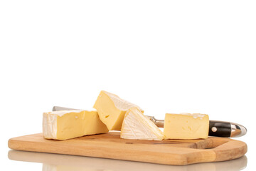 Fragrant brie cheese on a wooden kitchen board, macro, isolated on white background.
