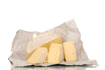 Fragrant brie cheese on a paper wrapper, macro, isolated on a white background.