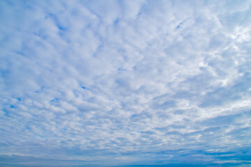 Background with sky and clouds receding into perspective.