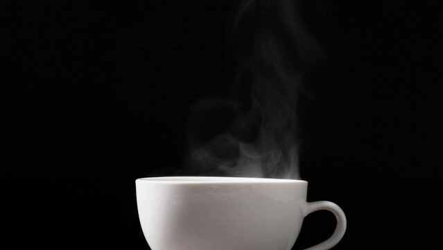 Coffee cup or tea cup with steam smoke of coffee on black background.