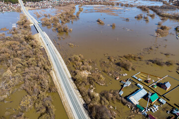 A countryside with a road flooded during the spring flood, aerial view