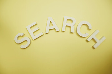 Search alphabet letters and magnifying top view on yellow background