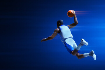 3d illustration young professional basketball player slam dunk on dark blue background