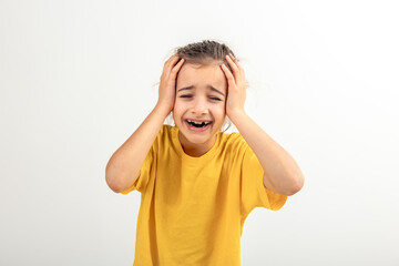 Fototapeta premium Little desperate girl looking panic, holding her head with both hands.