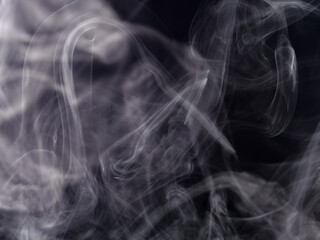 Abstract white smoke jets on black background