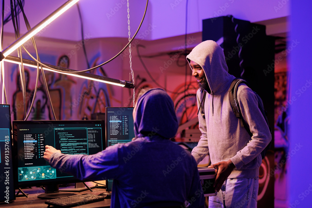 Poster hacker showing malware code on computer screen for data breach. criminals breaking law while program