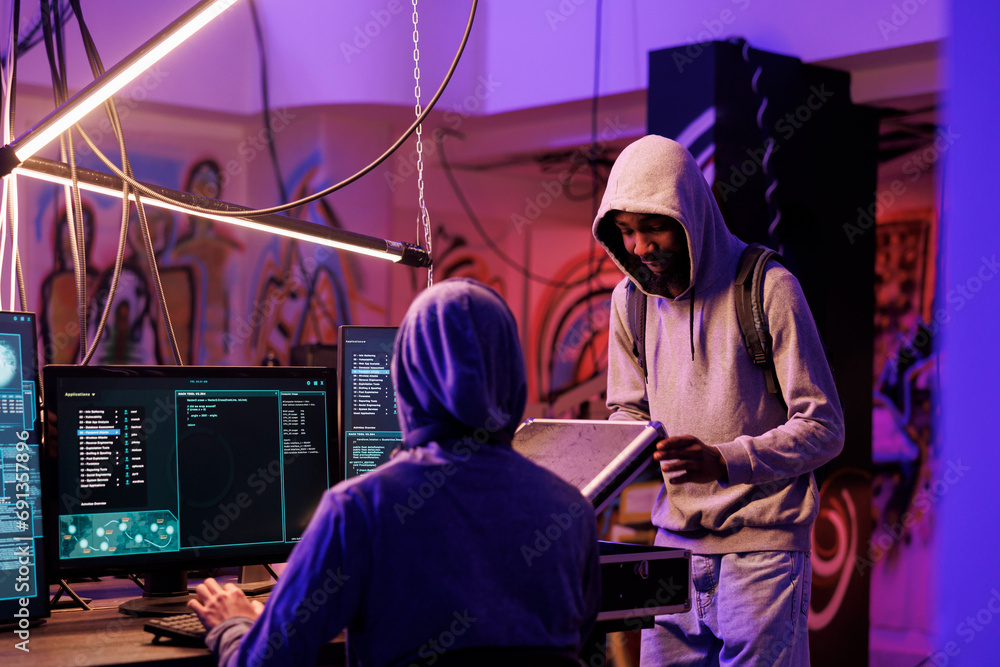 Poster hackers opening black box with illegal technology for network system hacking. internet criminals pla