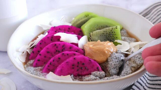 Chia pudding with tropical fruits: pittaya, kiwi, coconut and peanut butter.