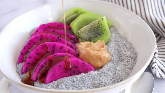 Chia pudding with tropical fruits: pittaya, kiwi, coconut and peanut butter.