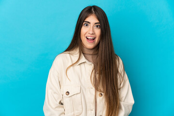 Young caucasian woman isolated on blue background with surprise facial expression