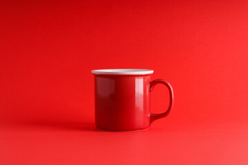 Red mug on an isolated red background, new year and christmas theme