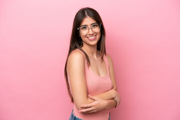 Young caucasian woman isolated on pink background with arms crossed and looking forward
