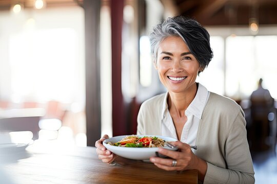 Healthy, Happy Adult Woman Enjoying Fresh Salad, Exuding Good Health And Being Active Indoors.