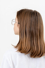Teen brunette girl on a white background isolated, view from the back.