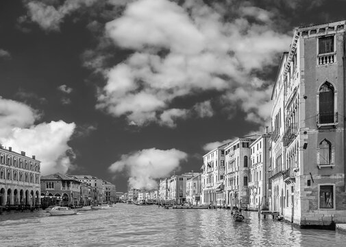 Beautiful black and white aerial view of the Grand Canal near the Rialto market, against a dramatic sky, Venice, Italy