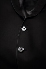 Clothes for a businessman. Stock photo of clothes. A black suit on a black background with a place for the inscription.