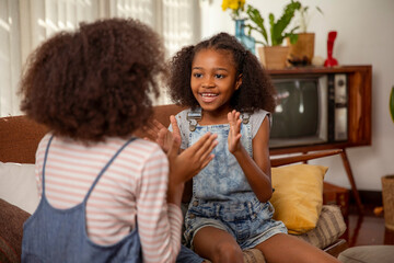 Girls playing clapping game at home