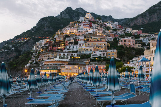 Italy, Campania, Positano, Empty deck chairs on Amalfi Coast beach at dusk