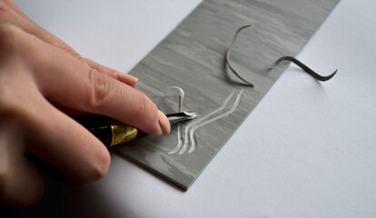 Artist's hands - linocut. Creation of handmade works. Art and design.