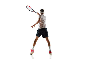 Back view image of young man in motion with racket, tennis player during game, training isolated...