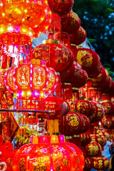 Many red lanterns with vietnamese language translated as "Happy New Year" hanging in Vietnam for Tet Lunar New Year