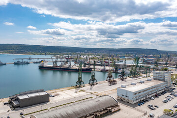 Industrial ports and cranes are ready to load from cargo ships.