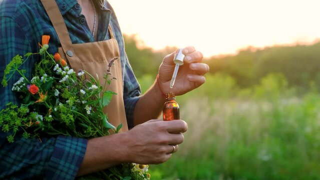 man with medicinal herbal extracts in his hands. Selective focus. nature.