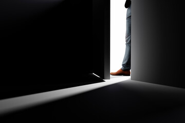 A man opens the door to a dark room. - obrazy, fototapety, plakaty