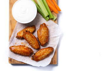 Buffalo spicy chicken wings with cayenne pepper sauce isolated on white background. Top view. Copy space